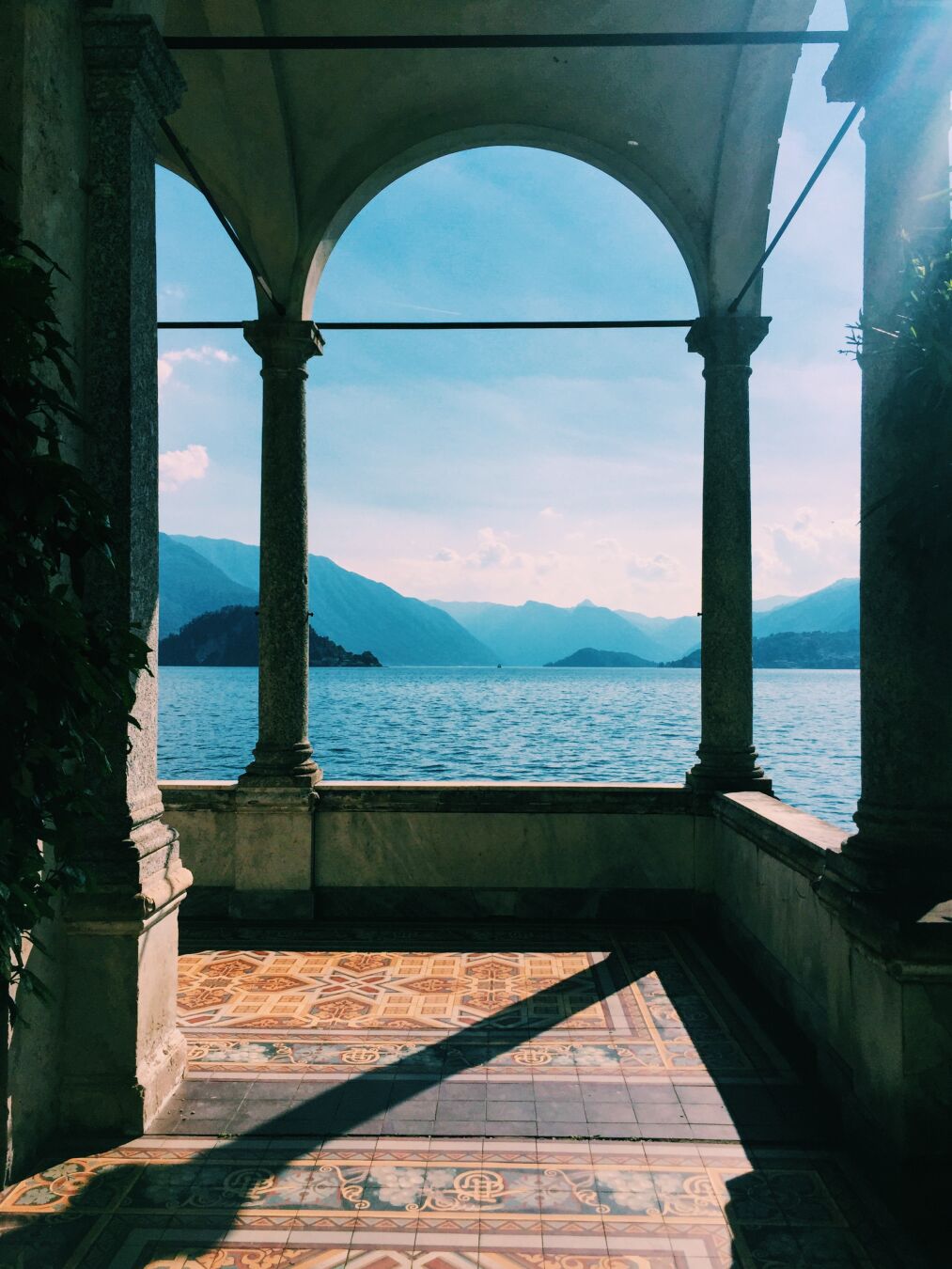 A photo of an archway in Villa Monastero looking out at Lake Como